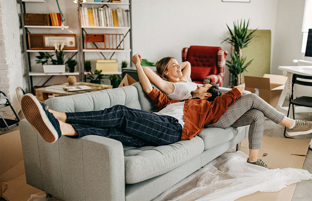 Emerald Air Conditioning Split System young couple on sofa