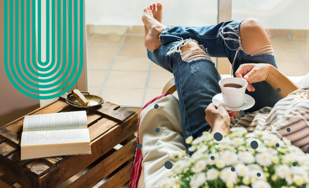 person lounging in aircon with coffee and book