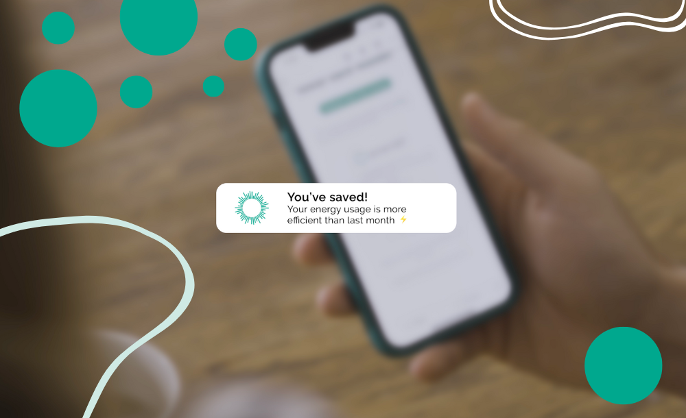 Mobile phone with pop up notification. "You've saved! Your energy usage is more efficient than last month."