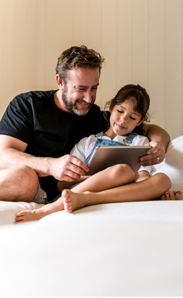 Emerald Air Conditioning Dad and daughter reading a book