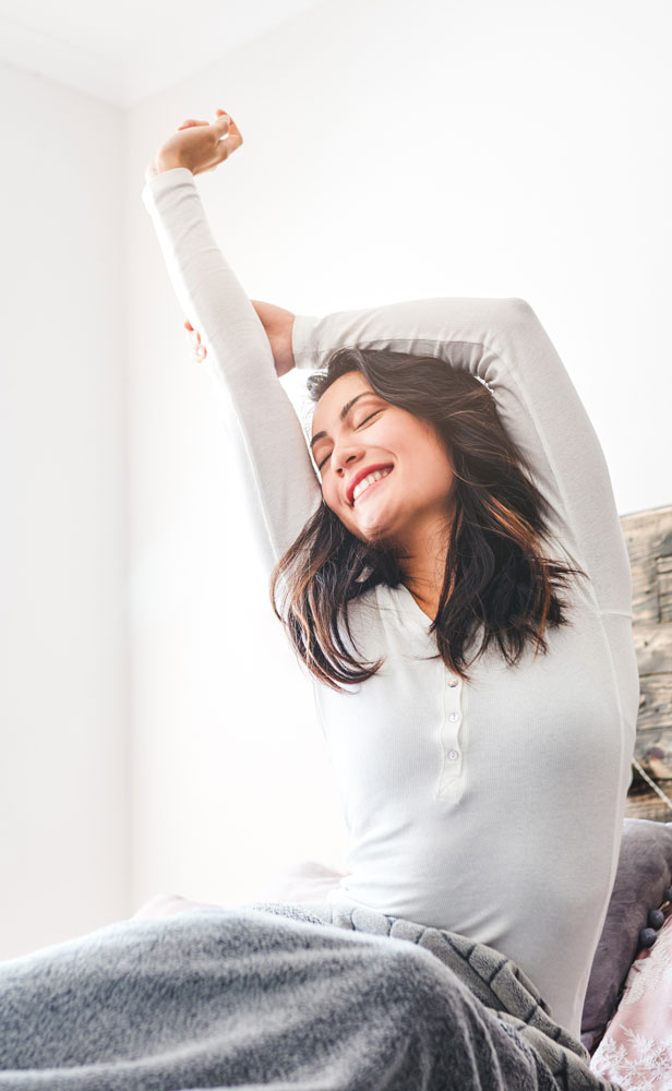Emerald Air Conditioning Lady stretching on bed